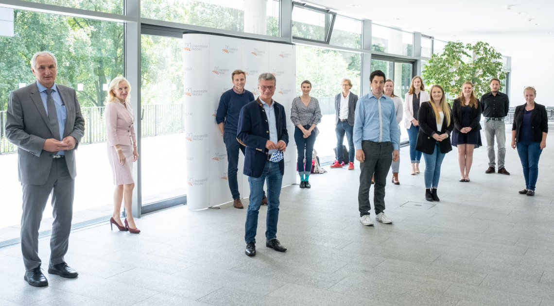 Wissenschaftsminister Bernd Sibler (4. v. l.) mit dem Präsidenten der Universität Passau Prof. Dr. Ulrich Bartosch (l.), der Vizepräsidentin Prof. Dr. Christina Hansen (2. v. l.) und Studentinnen und Studenten sowie jungen Wissenschaftler*Innen